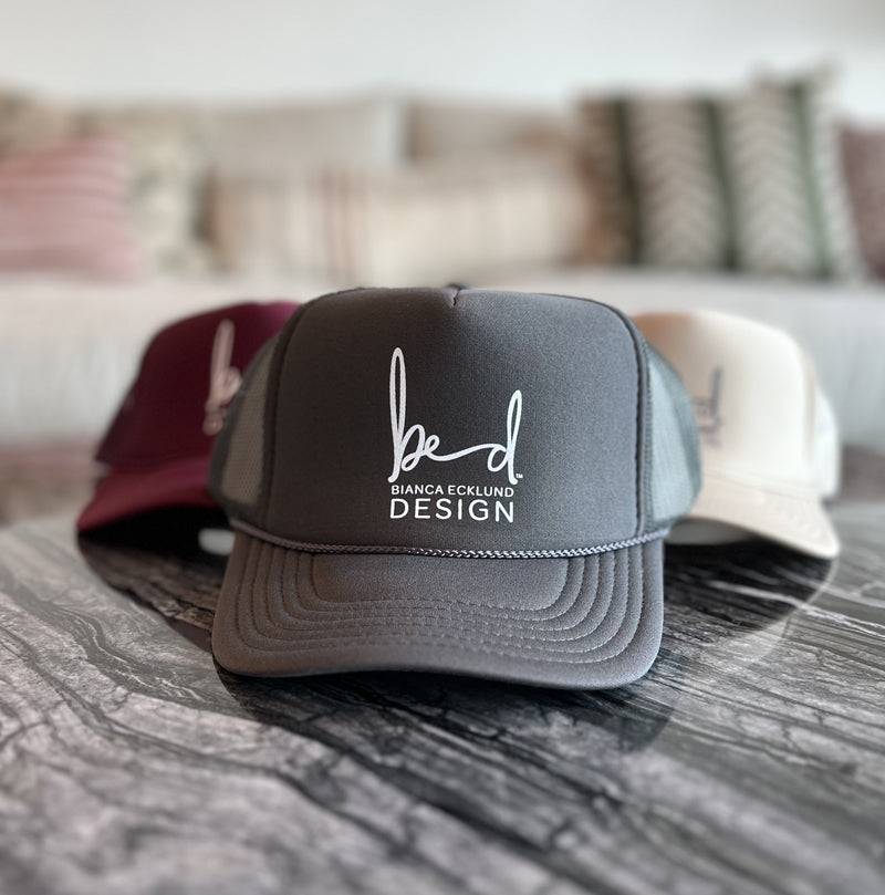trio of hats with bed logo