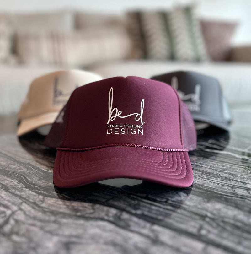 Maroon baseball hat with bed logo