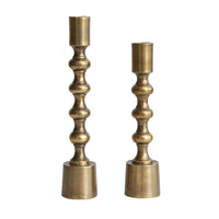 Two brass candle holders on a white background