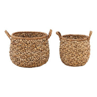 Two woven baskets made of natural material on a white background