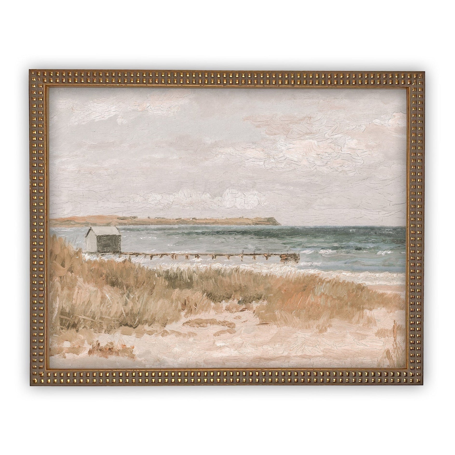 art in a beaded gold frame with a beach scene with a small dock and house on a white background 