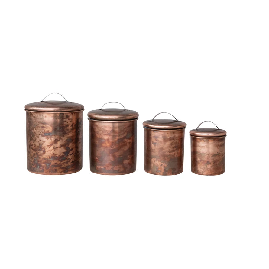 4 copper canisters of different sizes on a white background