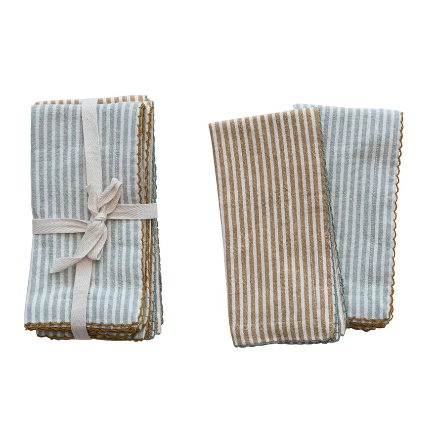 Two folded striped towels with a ribbon on a white background