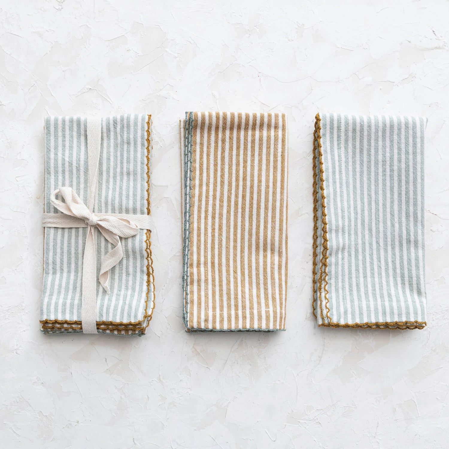 Three striped napkins on a light surface