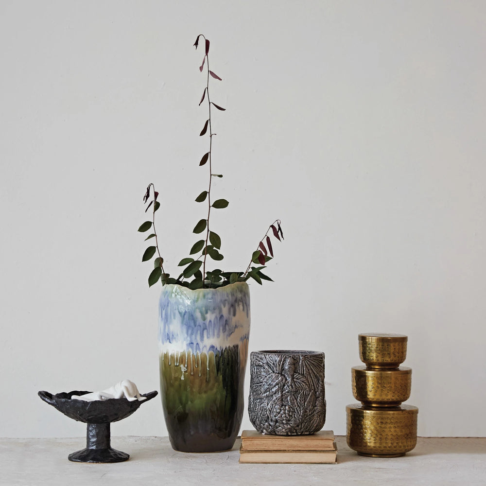 Collection of ceramic vases and containers on a light surface with a neutral background