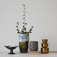 Collection of ceramic vases and containers on a light surface with a neutral background