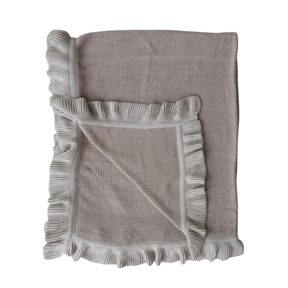Gray textured blanket with ruffled edges on a white background
